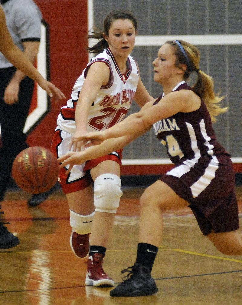 Ashley Briggs of Scarborough reaches for the ball Tuesday night as Bebe Butts of Windham, right, makes a pass during Scarborough’s 46-44 victory.