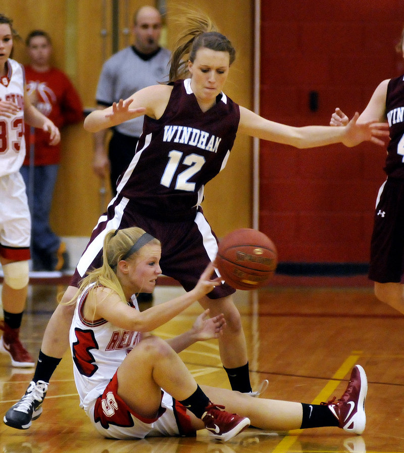 Maria Philbrick of Scarborough looks for an open teammate Tuesday night after grabbing a loose ball. Sam Frost defends for Windham. Scarborough came away with a 46-44 victory at home.