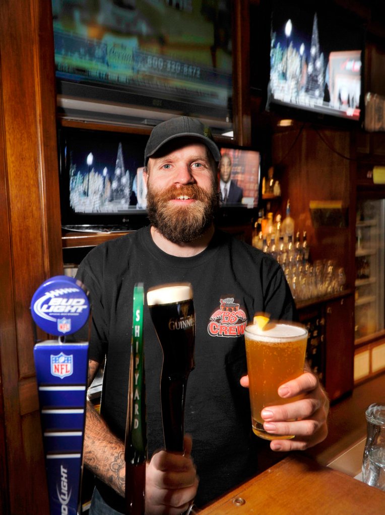 Bartender Marcus Payne serves a draft beer at Binga’s Stadium Smokehouse & Sports Bar in Portland, which offers plenty of cocktails and has 28 beers on tap.
