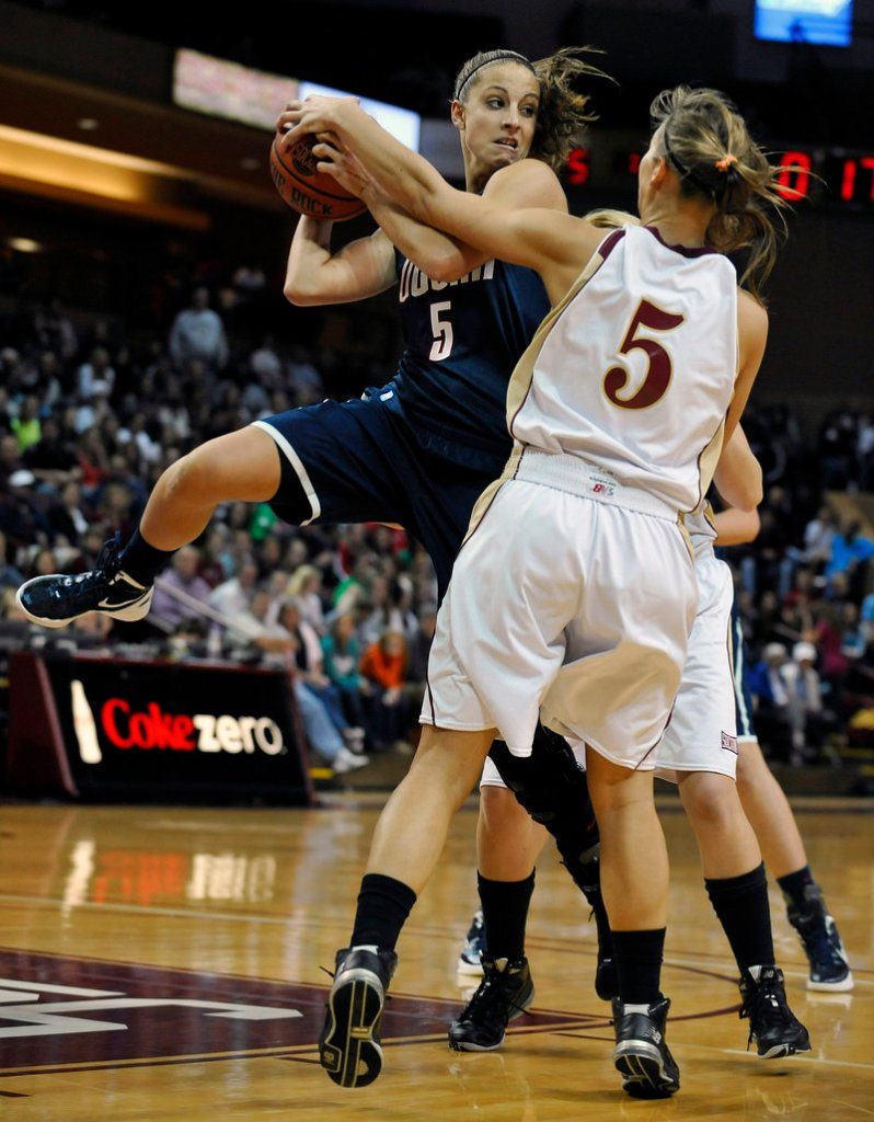 Caroline Doty of Connecticut looks to pass Wednesday night while defended by Cathryn Hardy of the College of Charleston. UConn, coming off a loss to Baylor, won 72-24.