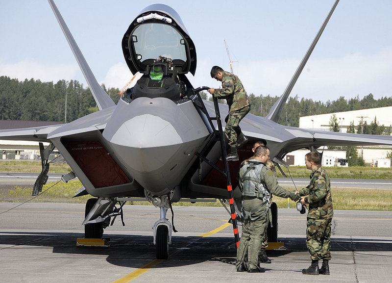 Lt. Col. Mike Shower, commander of the 90th Fighter Squadron, center, is greeted by crew chiefs after landing an F-22 fighter jet during an August 2007 arrival ceremony at Elmendorf Air Force Base in Anchorage, Alaska.