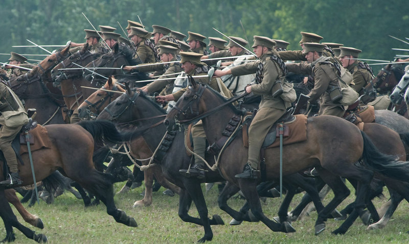 Sabres drawn, the British cavalry charges toward a German encampment in this scene from “War Horse.”