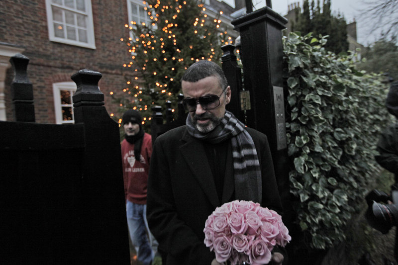 Singer George Michael, standing outside his home in London on Friday, said he is still weak from pneumonia.