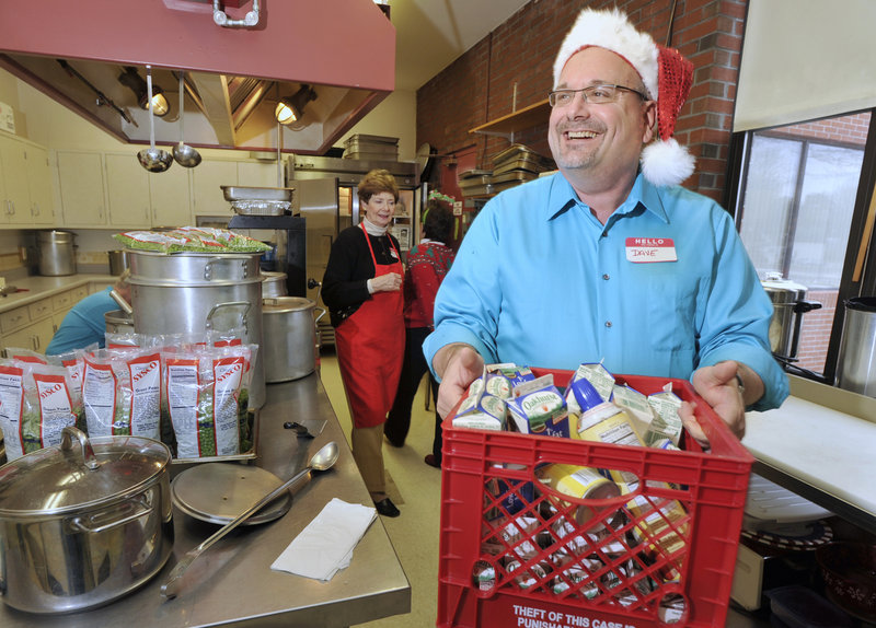 Dave Nadeau gets into the spirit of Christmas by wearing a Santa hat while volunteering at the Westbrook-Warren Congregational Church’s annual Christmas dinner for community members Sunday.
