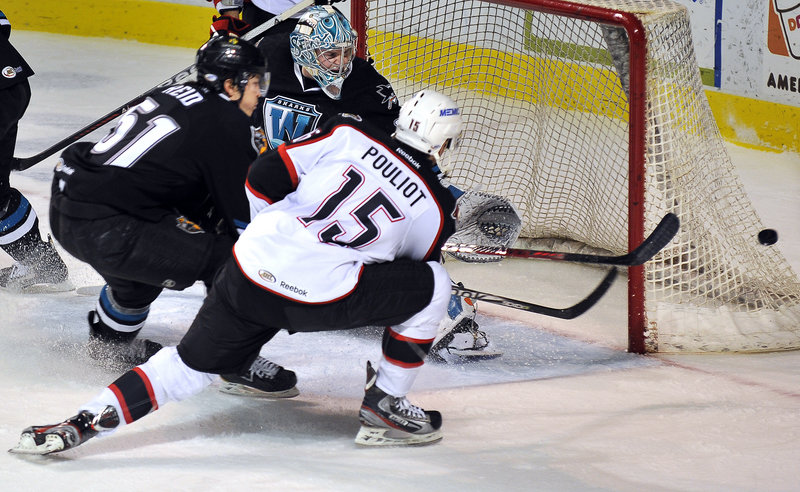 Marc-Antoine Pouliot of the Portland Pirates takes a pass from Brock Trotter past the stick of Sean Sullivan of the Worcester Sharks during Worcester’s 3-2 overtime victory.