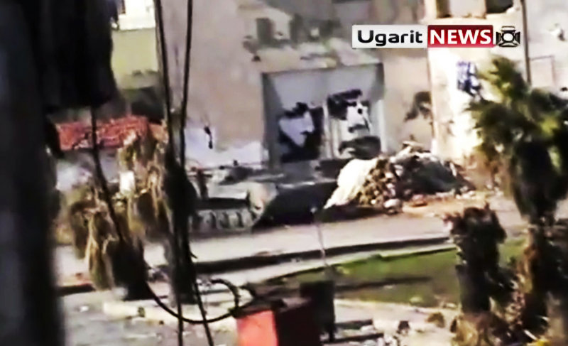 An amateur video released by Ugarit News Group Tuesday purports to show a Syrian military tank in Homs. Activists claim the tanks moved to side streets to mislead observers.