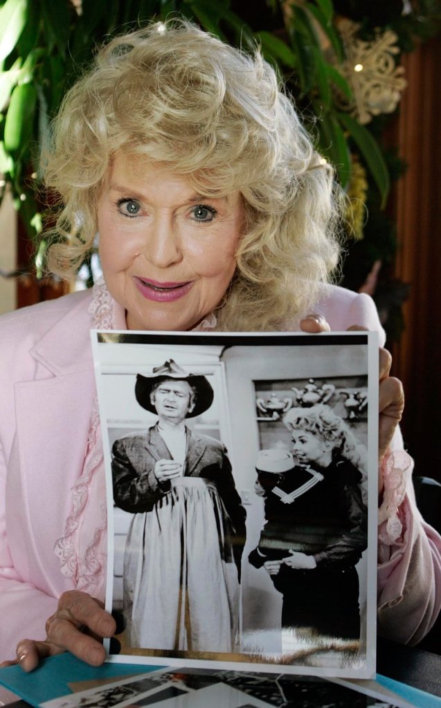 Donna Douglas, who starred in the television series “The Beverly Hillbillies,” holds a photo from the show in 2009.