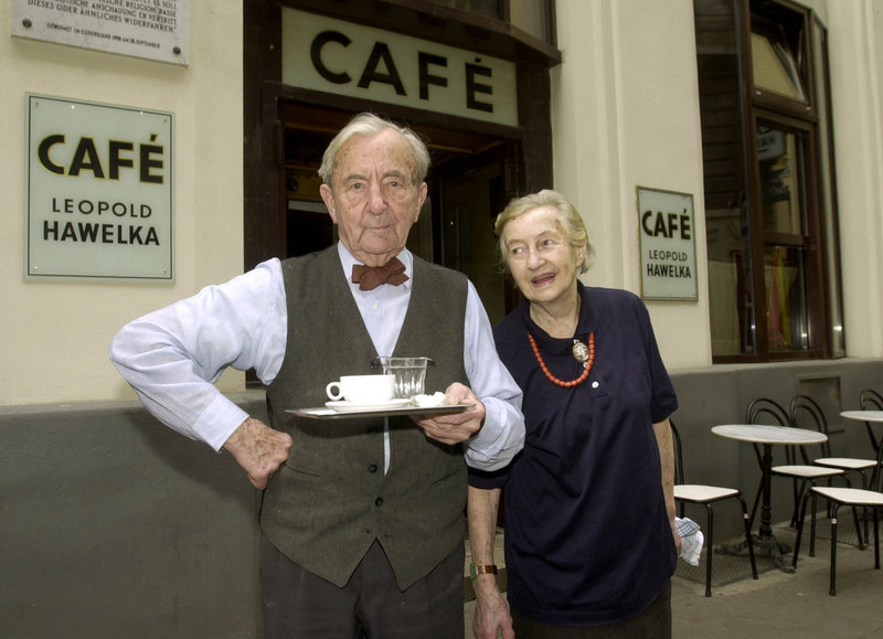 Leopold Hawelka poses with his wife, Josefine, in front of Cafe Hawelka in Vienna, Austria, in this April 26, 2001, file photo. Hawelka died Thursday at age 100.