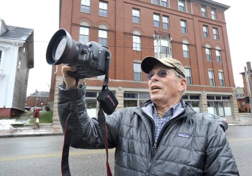Ted Oldham, a volunteer with the Maine Historical Society, takes a photo in Portland Friday.