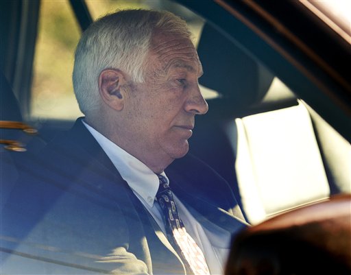 Former Penn State football defensive coordinator Jerry Sandusky sits in a car as he leaves the office of Centre County Magisterial District Judge Leslie A. Dutchcot on Saturday, Nov. 5, 2011, in State College, Pa. Sandusky was arrested again Wednesday on new sex-abuse charges from new accusers. (AP Photo/Andy Colwell, The Patriot-News)