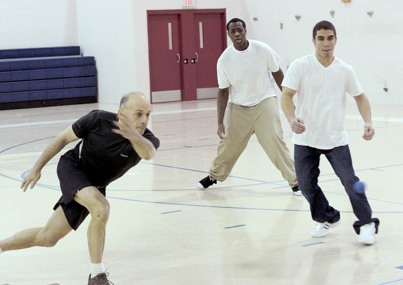 Ron Cramer, a retired police officer from San Francisco, plays handball recently with Alex Julien and E.J. Rosario at the Long Creek Youth Development Center in South Portland.