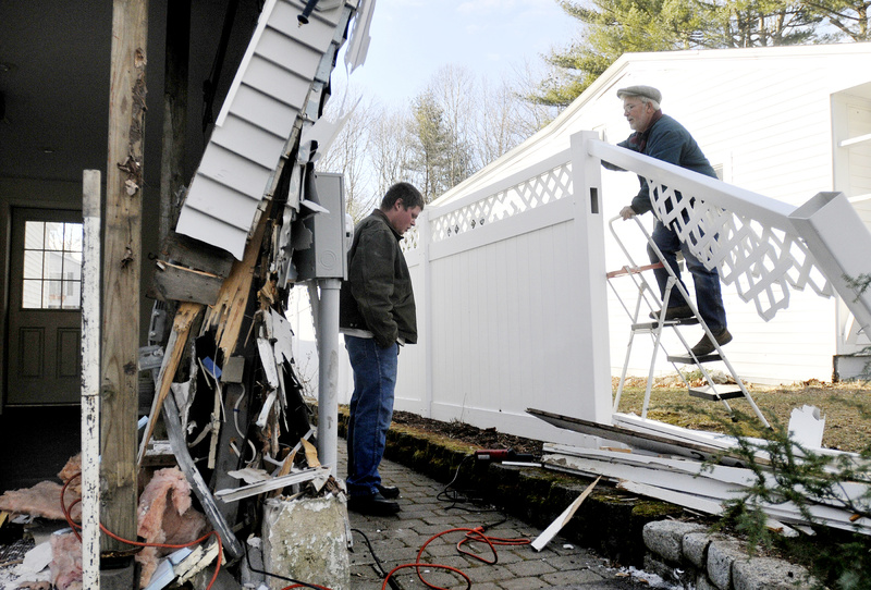 Gerard St. Ours, right, inspects damage from a single-car crash Sunday at 214 West St. in Biddeford. Police said 19-year-old Chaz Dorais of Biddeford died in the 1:30 a.m. crash when the car he was riding in left the road and hit a garage. The driver, Patrick Beatson, 19, of Biddeford was taken to Maine Medical Center with injuries that were not life-threatening. Also looking over the damage is Tom Gilman of Biddeford.