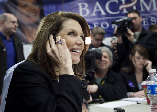 Republican presidential candidate Rep. Michele Bachmann, of Minnesota, makes phone calls during a stop at her campaign headquarters on Saturday, Dec. 31, 2011, in Urbandale, Iowa. (AP Photo/Evan Vucci)