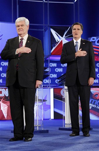 Republican presidential candidates Newt Gingrich and Mitt Romney stand during the National Anthem at the Republican presidential candidates debate at the University of North Florida in Jacksonville on Thursday.