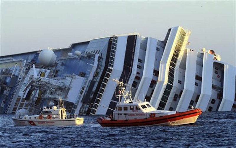 The luxury cruise ship Costa Concordia leans on its side as after running aground off the tiny Tuscan island of Giglio. (AP Photo/Enzo Russo)