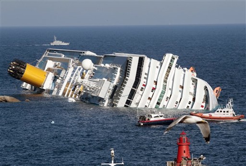 The luxury cruise ship Costa Concordia lays on its side after running aground the tiny Tuscan island of Giglio, Italy. (AP Photo/Gregorio Borgia)