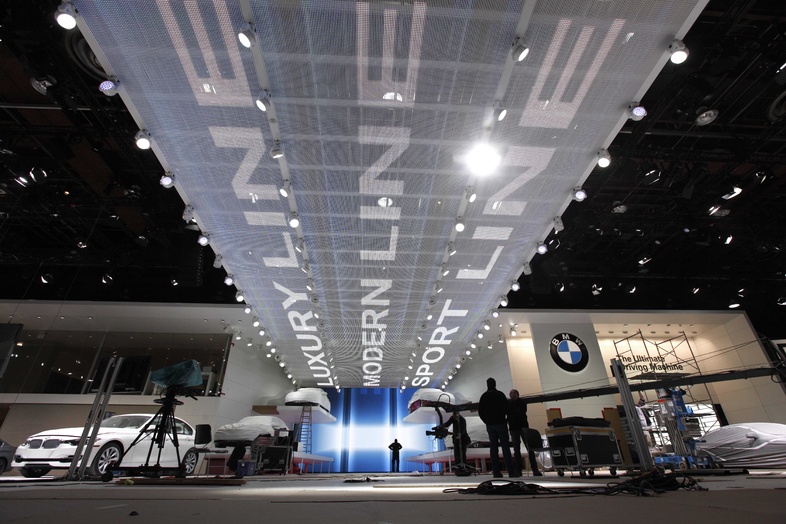 Workers prepare exhibit space at COBO Center in preparation for the North American International Auto Show in Detroit.