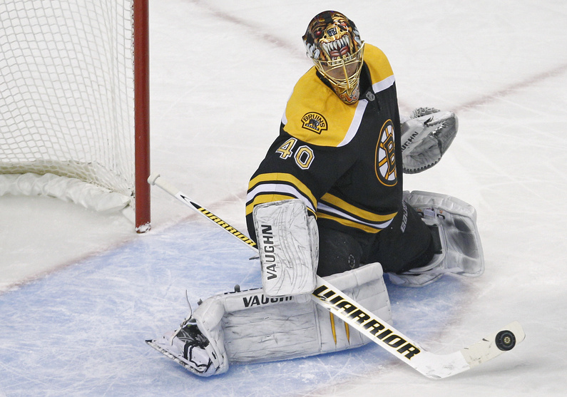 Boston Bruins goalie Tuukka Rask makes a stick-save in the Bruins' 9-0 shutout against the Calgary Flames in Boston tonight.