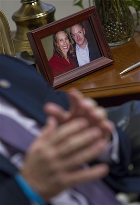 Ron Barber, backdropped by a photo of U.S. Rep. Gabrielle Giffords and her husband, Mark Kelly, recounts the day he was shot. Barber, A staffer for Giffords, was shot one year ago while working a Giffords event where a gunman opened fire on Giffords and the crowd. (AP Photo/Matt York)