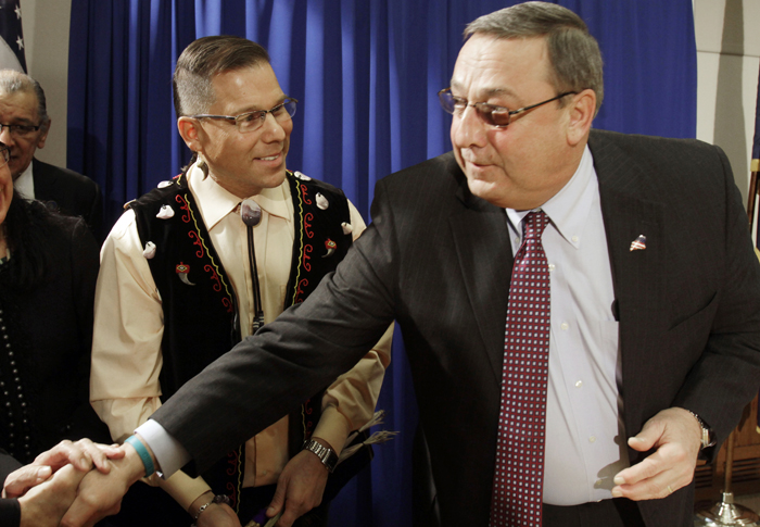 David Slagger, a member of the Maliseet tribe, smiles as Gov. Paul LePage reaches to shake hands prior to Slagger's swearing-in at the State House today.