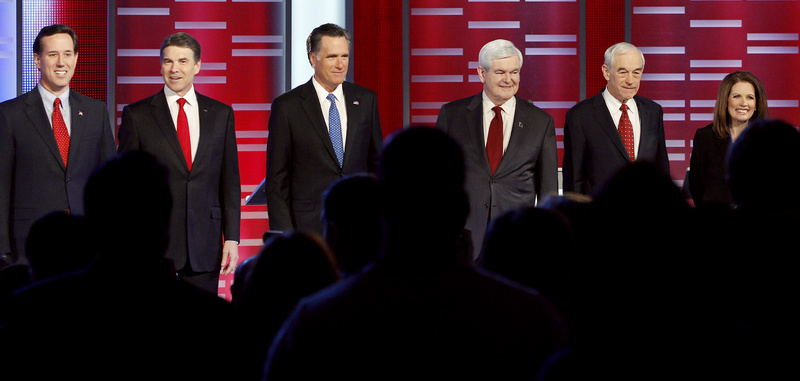 Republican presidential candidates, from left, former Pennsylvania Sen. Rick Santorum, Texas Gov. Rick Perry, former Massachusetts Gov. Mitt Romney, former Speaker of the House Newt Gingrich, Rep. Ron Paul, R-Texas, and Rep. Michele Bachmann, R-Minn, stand together prior to their Republican debate in Des Moines, Iowa, on Dec. 1.