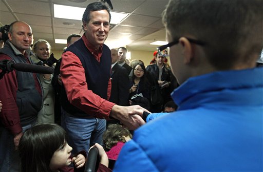 Republican presidential candidate Rick Santorum reaches to greet children during a campaign stop in Brentwood, N.H., on Wednesday.