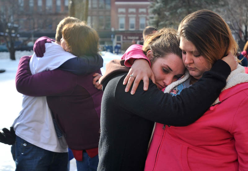 Trista Reynolds, center, mother of Ayla Reynolds, is comforted by her friend Amanda Benner during Saturday's vigil for Ayla in Castonguay Square in Waterville.
