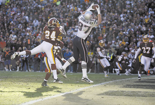Rob Gronkowski (87) catches a touchdown pass over Washington Redskins strong safety DeJon Gomes (24) during the Patriots win over the Washington Redskins. Gronkowski led the NFL in touchdown catches.
