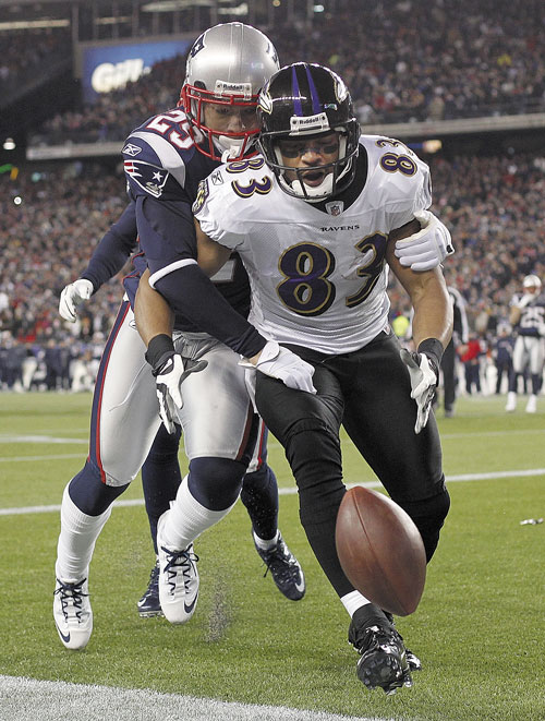 Sterling Moore of the Patriots knocks the ball away from Ravens wide receiver Lee Evans, preventing what would have been a go-ahead touchdown for Baltimore with less than 30 seconds remaining.
