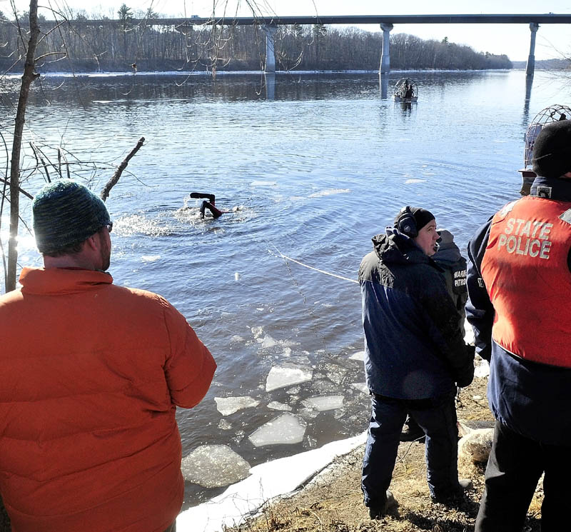 MASSIVE SEARCH: A diver heads back underwater as a search boat motors above the Carter Memorial Bridge in the Kennebec River as state police and the Maine Warden Search conducted an extensive search of the river for signs of missing toddler Ayla Reynolds on Wednesday.