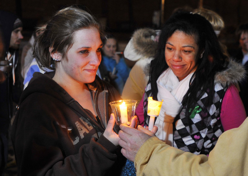 Ayla’s mother, Trista Reynolds, left, attends a candlelight vigil in Portland on Dec. 23.