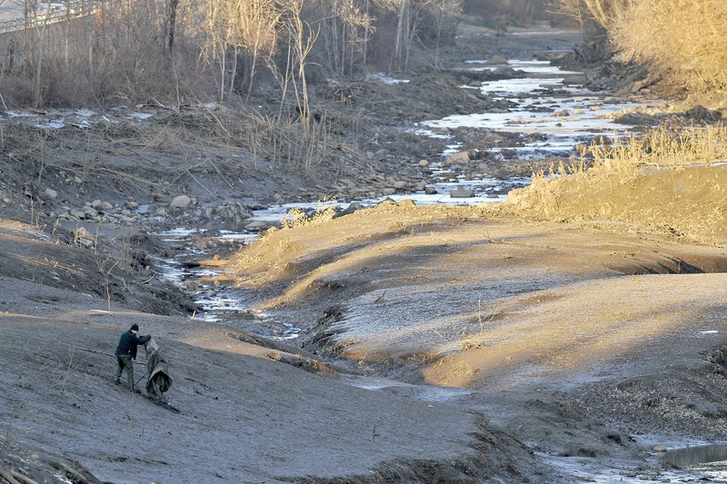 A stretch of the Messalonskee River is drained as part of the intensive search for 20-month-old Ayla Reynolds in Waterville on Dec. 20.