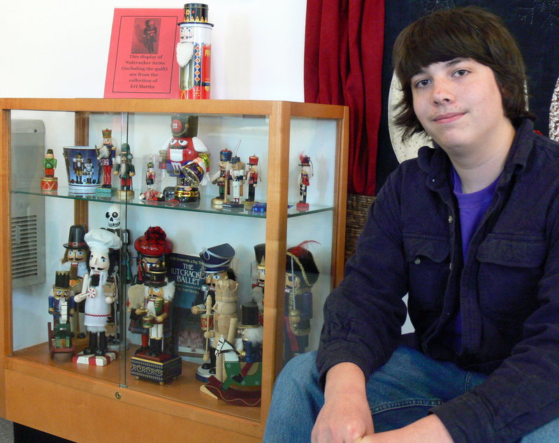 Eri Martin, 14, poses with his collection of nutcrackers at the Windham Public Library.