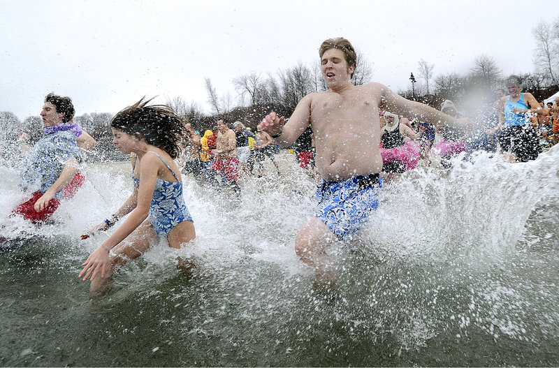 Seventeen-year-old Zach Greenham of Readfield, at right, was among more than 100 bathers who participated in the annual Polar Bear Plunge at the East End Beach in Portland on Saturday.