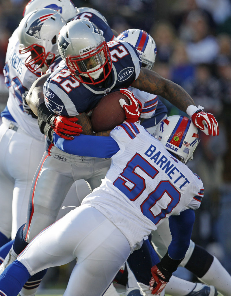 Stevan Ridley of the Pats, who led the team with 81 rushing yards on 15 carries, gets stopped by Buffalo’s Nick Barnett in Sunday’s game at Gillette Stadium.