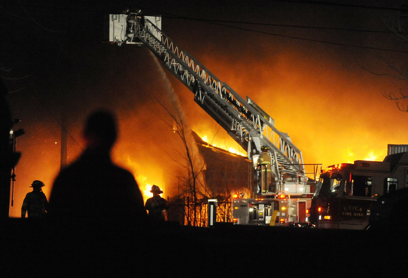 A fire burns early Sunday at the former Westclox Co. clock factory in Peru, Ill. Despite the efforts of firefighters from the surrounding area, the landmark was destroyed by the blaze.