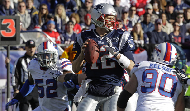 Tom Brady sets up to throw in the first quarter Sunday against the Bills. Brady threw for three TDs as he rallied the Patriots from a three-TD deficit to a 49-21 win at Gillette Stadium, giving New England the top seed in the AFC.