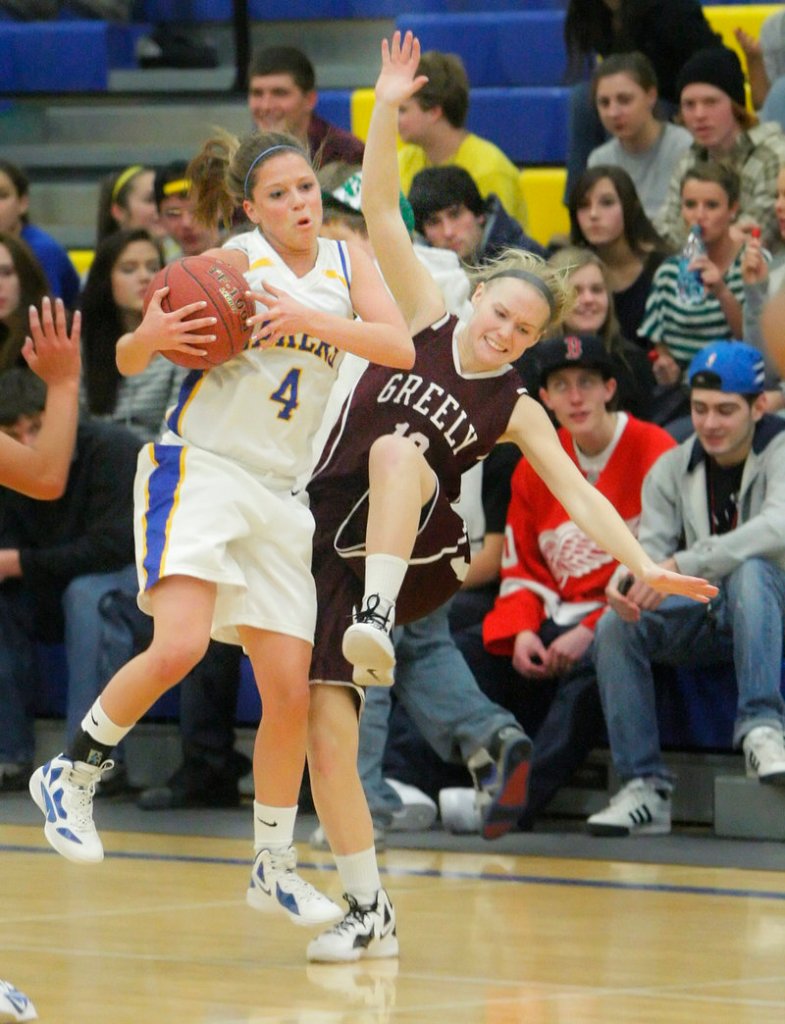 Sydney Hancock of Lake Region controls a loose ball and keeps it from Caroline Hamilton of Greely during Lake Region’s 40-27 victory at home Wednesday night.