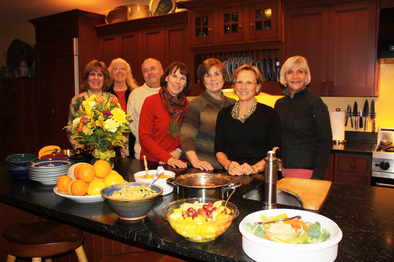 Pat Harford, left, Nancy Randolph, Tom Ranello, Ann Lebel, Jane Honeck, Susan Lebel Young and Julia Ranello gather in Young’s Falmouth kitchen to enjoy a 30 Day Real Food Challenge potluck.