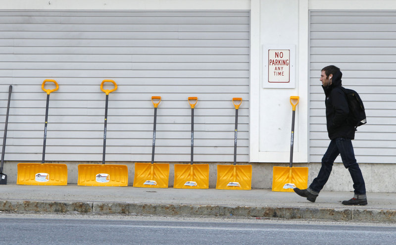 In downtown Bridgton, snow shovels are lined up for sale outside a Renys store. Across much of the nation, most natural snow has either melted or been washed away by rain, costing businesses tens of millions of dollars in lost sales.