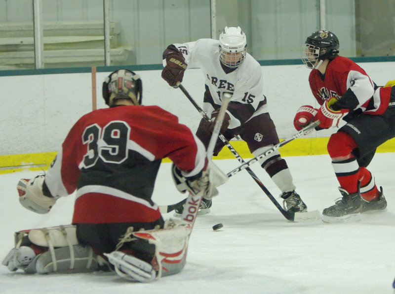 John Wright of Greely looks for room to shoot on Camden Hills goalie Aaron Daniello while Jordan Tyler defends Thursday night during Greely’s 4-2 victory at the Family Ice Center. The Rangers improved to 4-0-1 and dropped the Windjammers to 2-2.
