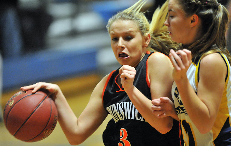 Erica French of Brunswick drives against Mackenzie Conlogue during Mt. Blue’s 58-32 win Friday night in Farmington.