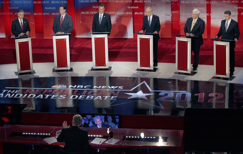 From left, Jon Huntsman, Rick Santorum, Mitt Romney, Ron Paul, Newt Gingrich and Rick Perry listen to a question from NBC “Meet the Press” moderator David Gregory during a debate in Concord, N.H., on Sunday. The nomination fight is becoming increasingly acerbic.