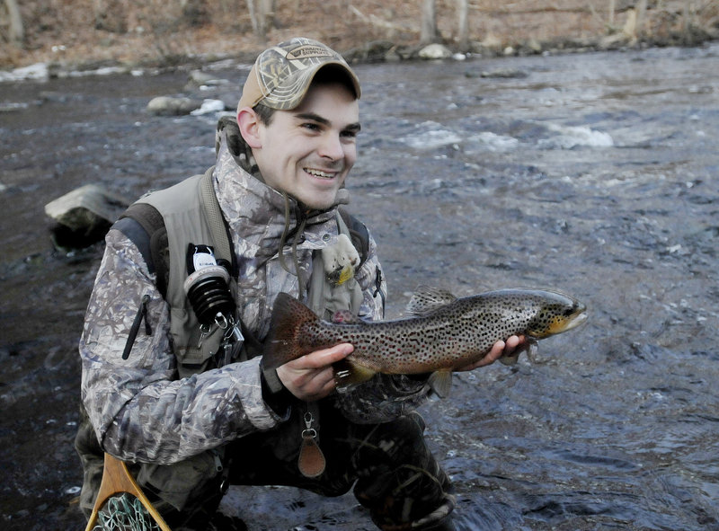 Dan Dykstra of Old Town shows off a brown trout he caught Jan. 8 in the Mousam River in Kennebunk during the ninth annual Freeze Up, a gathering of fly fishermen held each January.