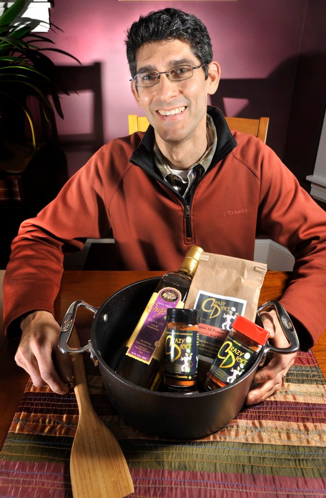 Rich Curole is making and selling an organic spice blend that reflects his Cajun heritage. In front of him is a Cajun gift set, which includes the two Crazy Dick’s spice blends, organic extra virgin olive oil, organic flour, a wooden paddle and a cast iron dutch oven. It’s available online, and sells for $163.95.