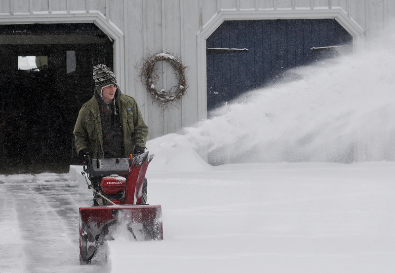 William O’Brien of Scarborough blows snow from his family’s yard on Pine Point Road in Scarborough on Thursday. The town got 10 inches.