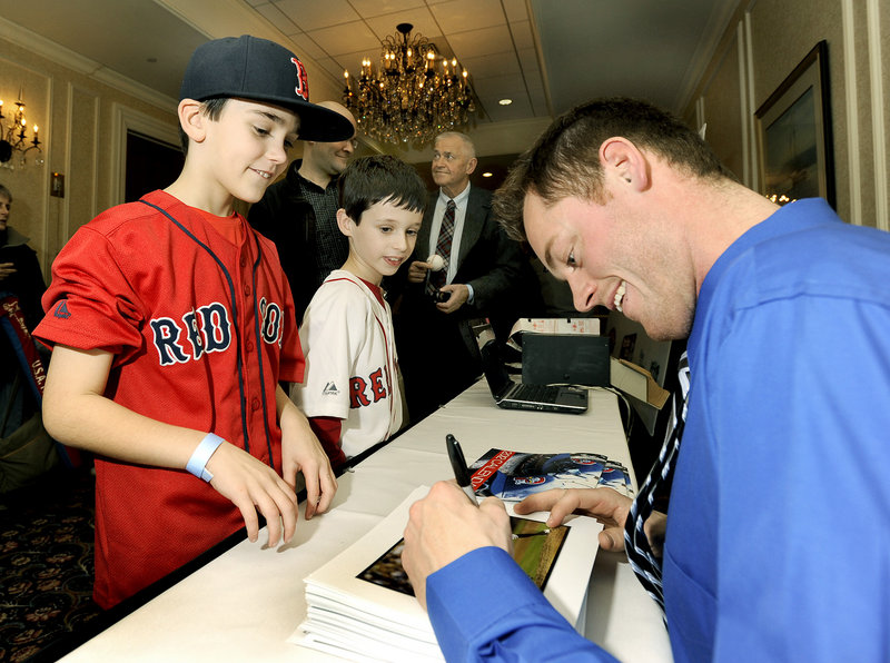 Joey Lancia, 9, left, and Brayden Young, 8, both of Portland, wait Friday for a signed photo from South Portland native and big-league pitcher Charlie Furbush at the annual Portland Sea Dogs’ Hot Stove Dinner & Silent Auction at the Marriott at Sable Oaks in South Portland.