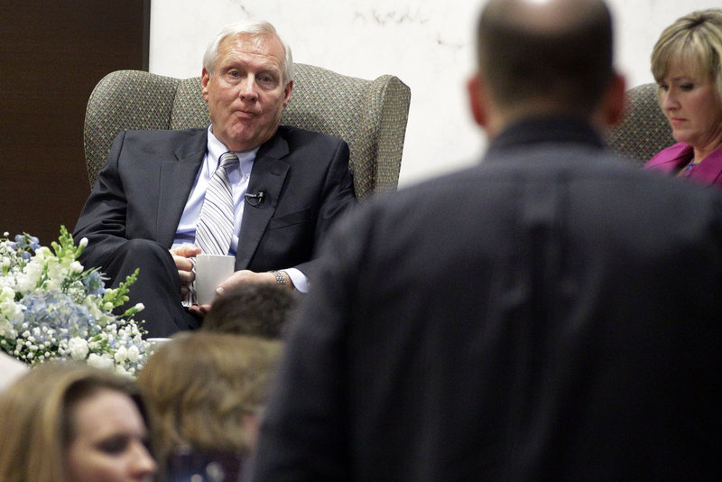 Penn State University President Rodney Erickson, left, listens to a question at a town hall meeting with alumni in Pittsburgh, one of three sessions in three cities last week.