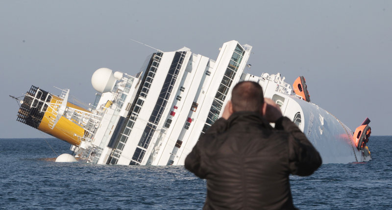 The luxury cruise ship Costa Concordia lists on its side after running aground off Giglio, Italy, sending water pouring in through a 160-foot gash in the hull and forcing the evacuation of some 4,200 people.