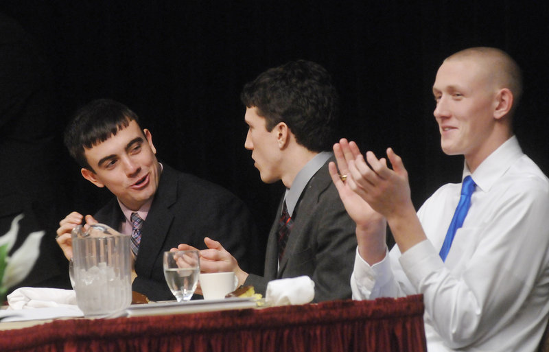 Jordan Hersom, left, of Leavitt, Louis DiTomasso, center, of Wells and Spencer Cook of Cheverus share the head table at the Fitzpatrick Trophy banquet Sunday at the Holiday Inn by the Bay in Portland.